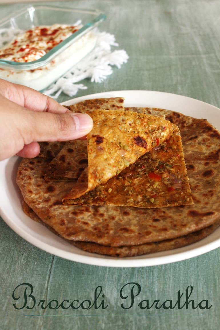 Opening broccoli paratha layer to show inside stuffing.
