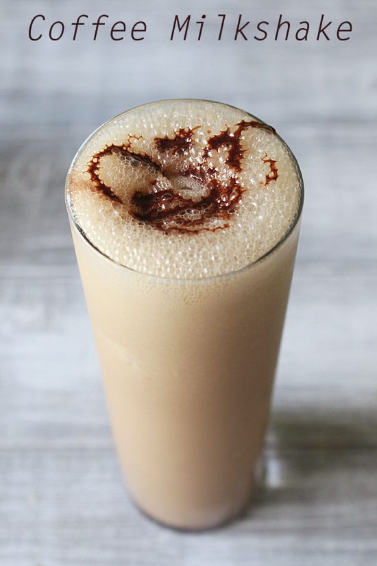 Coffee milkshake served in a tall glass with a drizzle of chocolate sauce on top.