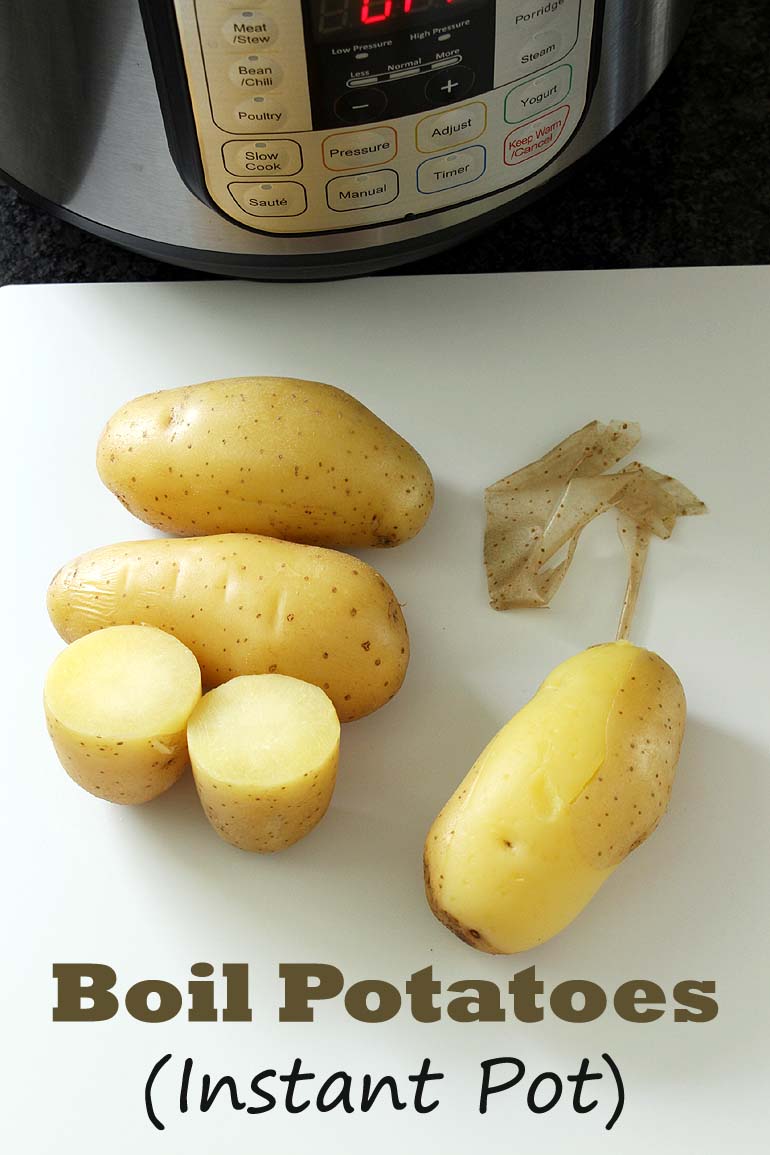 Boiled potatoes on a cutting board and instant pot in the back.