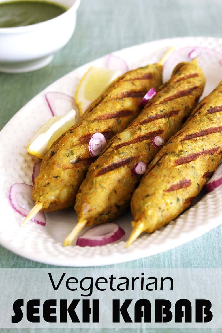 Veg seekh kabab served with onions and lemon wedges.
