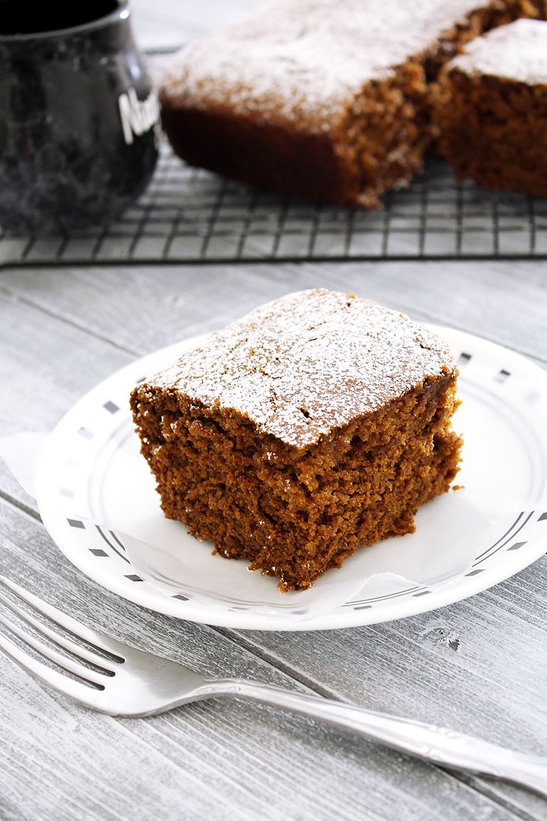 Eggless gingerbread cake piece in a plate with fork.