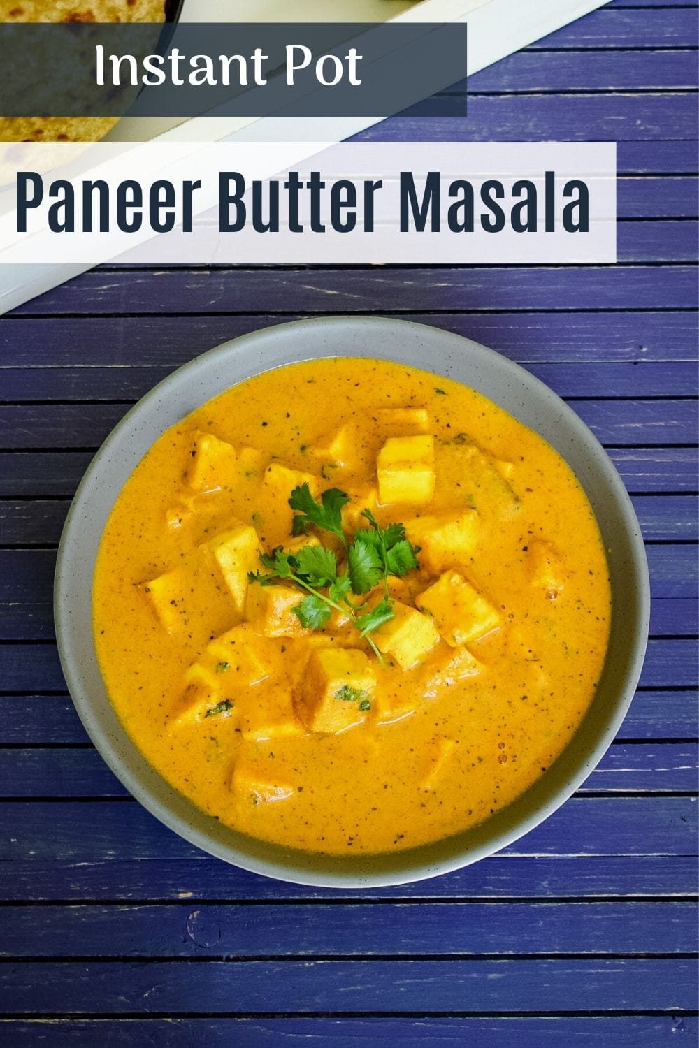 paneer butter masala in a bowl with garnish of cilantro with text on the image of pinterest