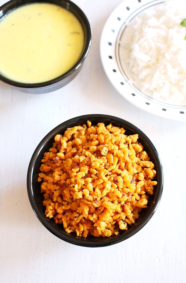 Sookhi moong dal served with rice and kadhi in the back.