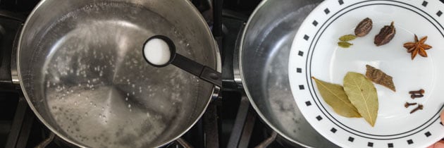 boiling water with salt, spices to cook rice for paneer biryani