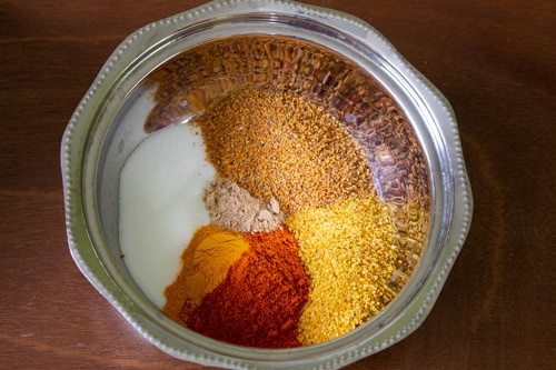 all the spices in a bowl to make mango pickle