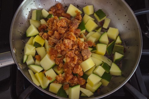 adding raw mango pieces and jaggery