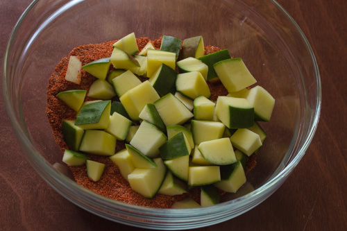 raw mango pieces are added to the spice mixture