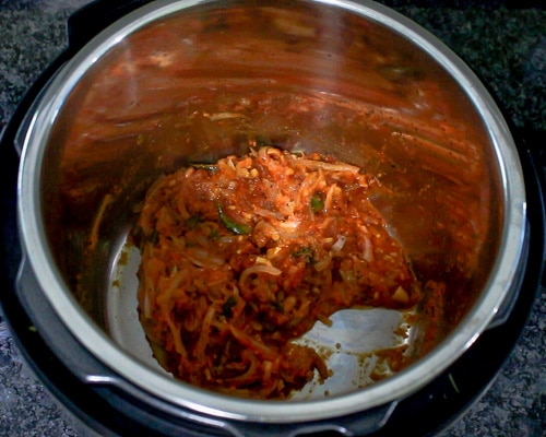 spice powders mixed with cooked tomatoes