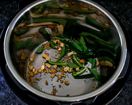 adding green chilies and curry leaves