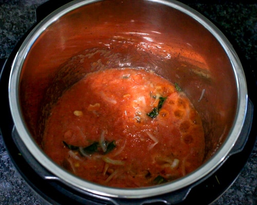 adding and simmering tomato puree