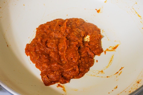 spice powders are mixed into the cooked tomato puree