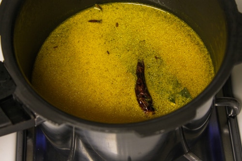 Adding water to make moong dal khichdi