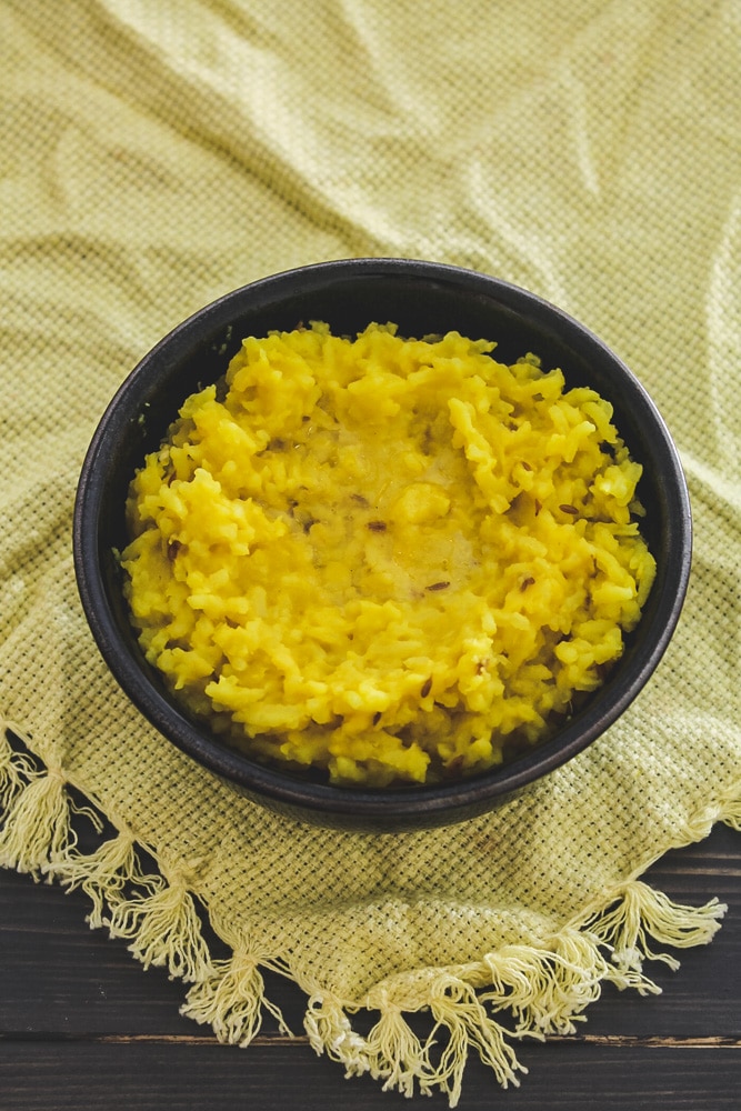 Moong Dal Khichdi in a bowl with ghee on top.