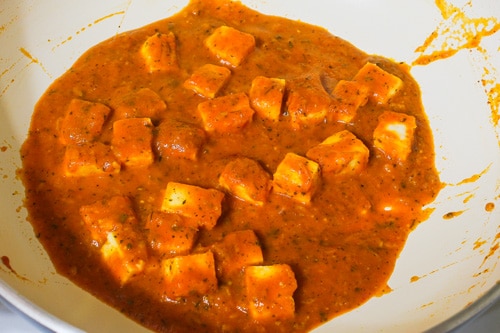mixing paneer and simmering gravy