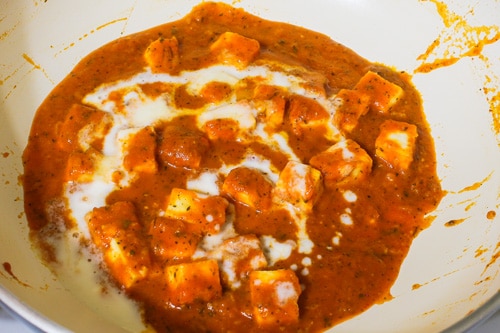 adding heavy cream to paneer makhani