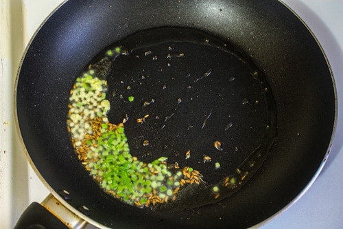 chopped ginger and green chilies into hot oil