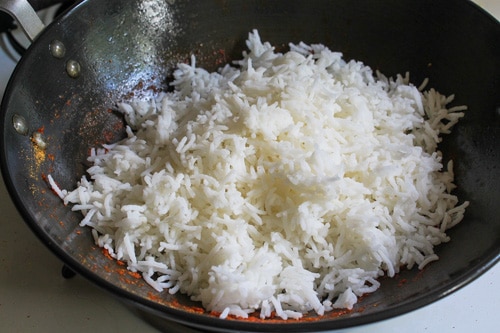 adding cooked rice to the tomato mixture