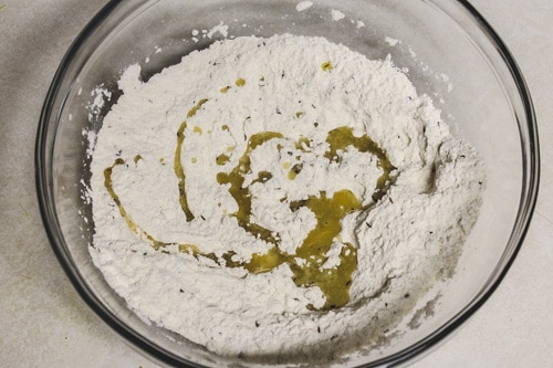 adding ghee to flour mixture