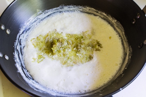 adding cooked lauki to simmering milk