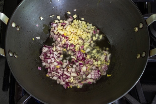 adding onion and garlic to olive oil