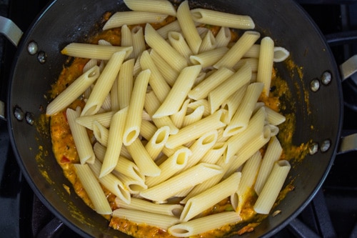 adding cooked pasta