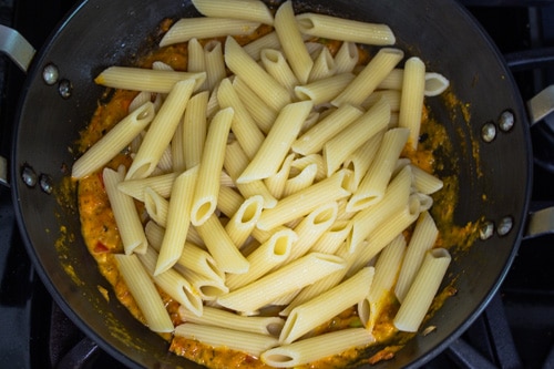 adding cooked pasta