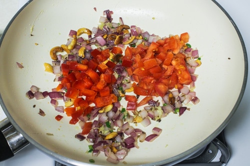 adding tomato and capsicum