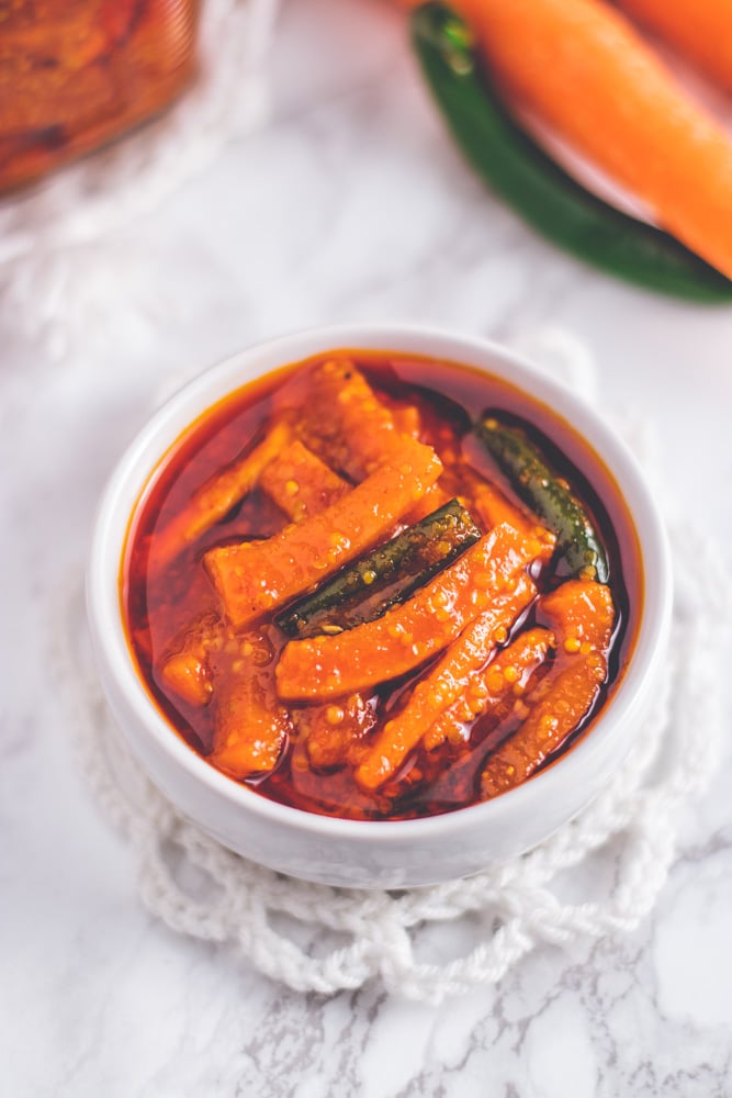 Carrot pickle in a small white bowl.