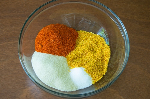 rai kuria, red chili powder, salt and sugar in a bowl