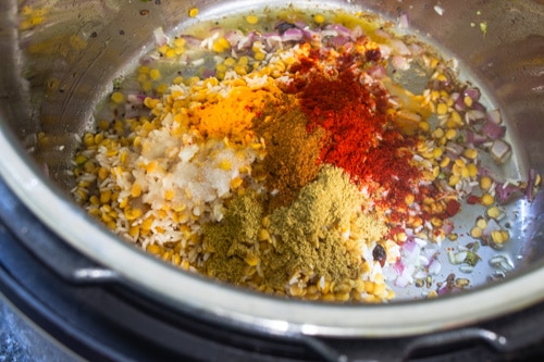 adding dal-rice and spice powders