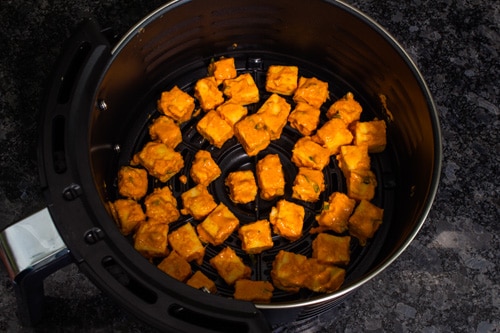 batter coated paneer in air fryer basket