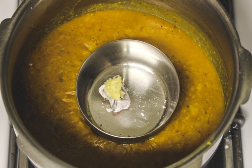 adding garlic paste on the charcoal