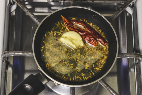 adding dried red chilies and garlic
