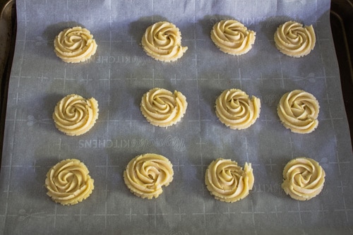 piped cookies on baking tray