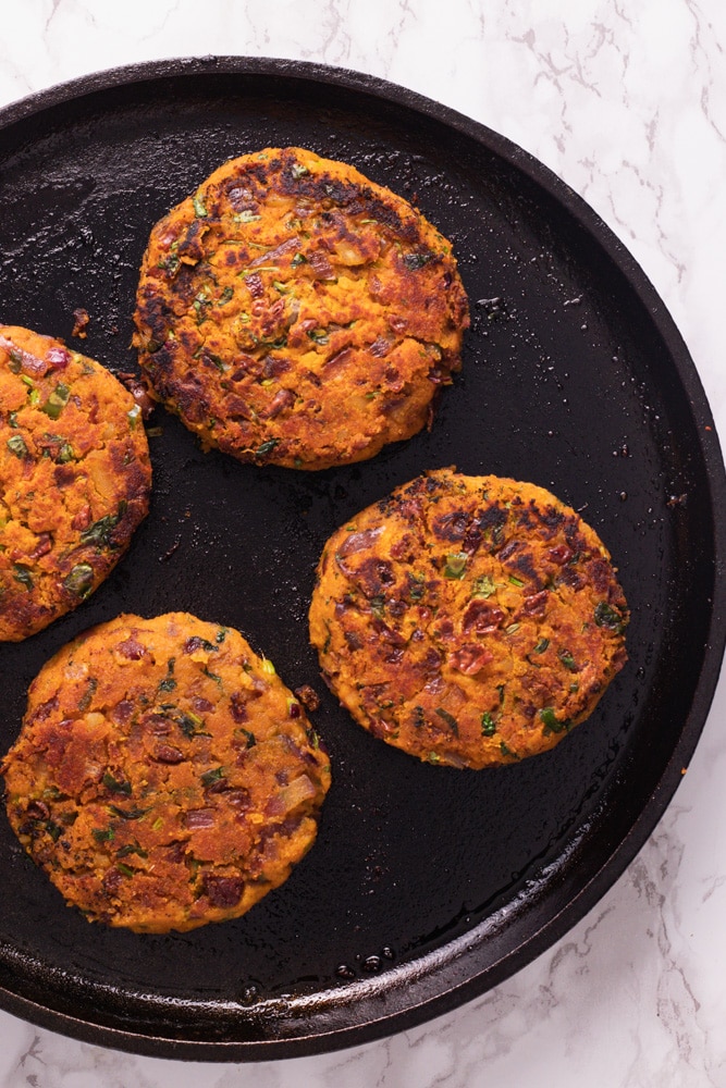 kidney bean burger patty in a cast iron skillet 