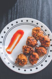 Dill leaves pakoda in a plate with ketchup on side