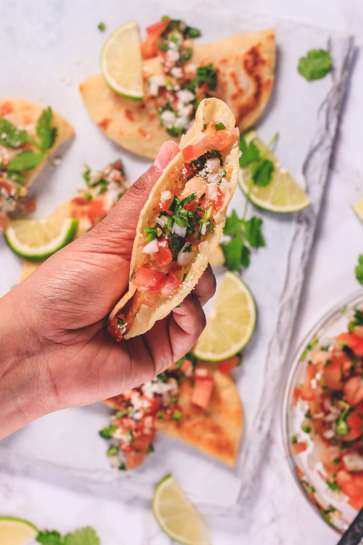 Close up of crispy potato taco in the hand