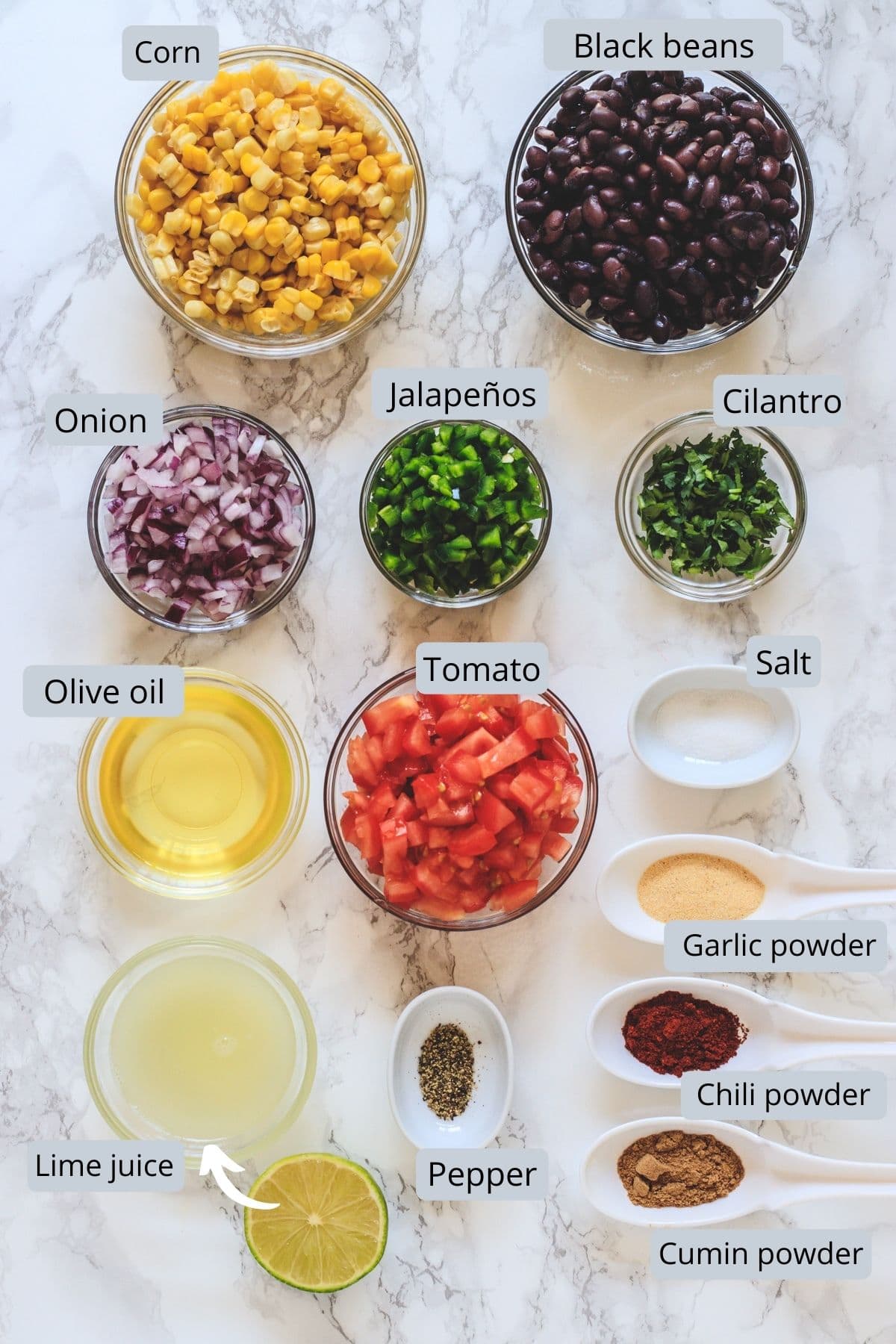 Black bean and corn salsa ingredients in bowls and spoons with labels.