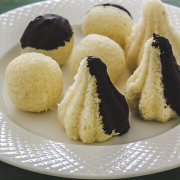 Image of chocolate coated coconut modak and ladoo on a plate