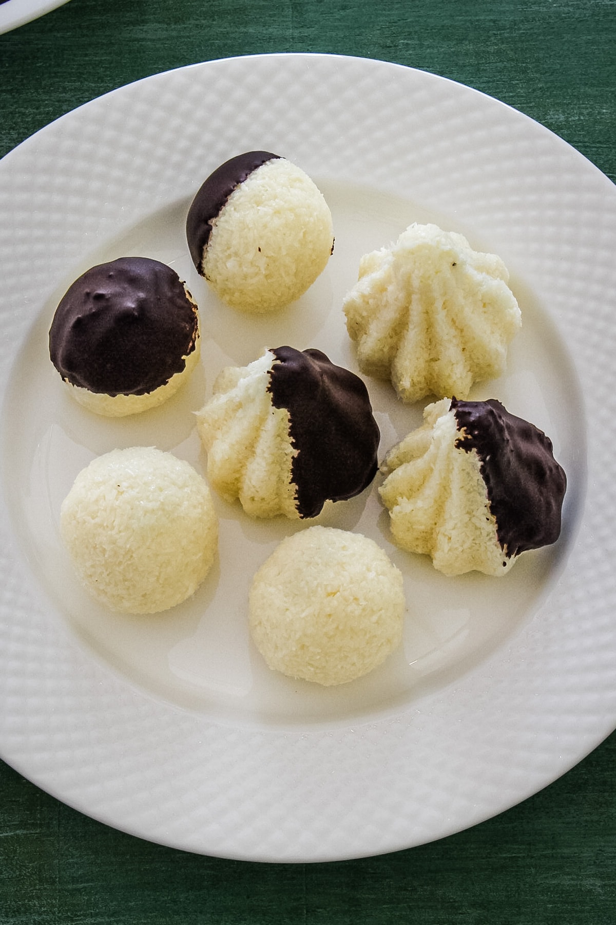 Top view of chocolate coated coconut modak on a white plate