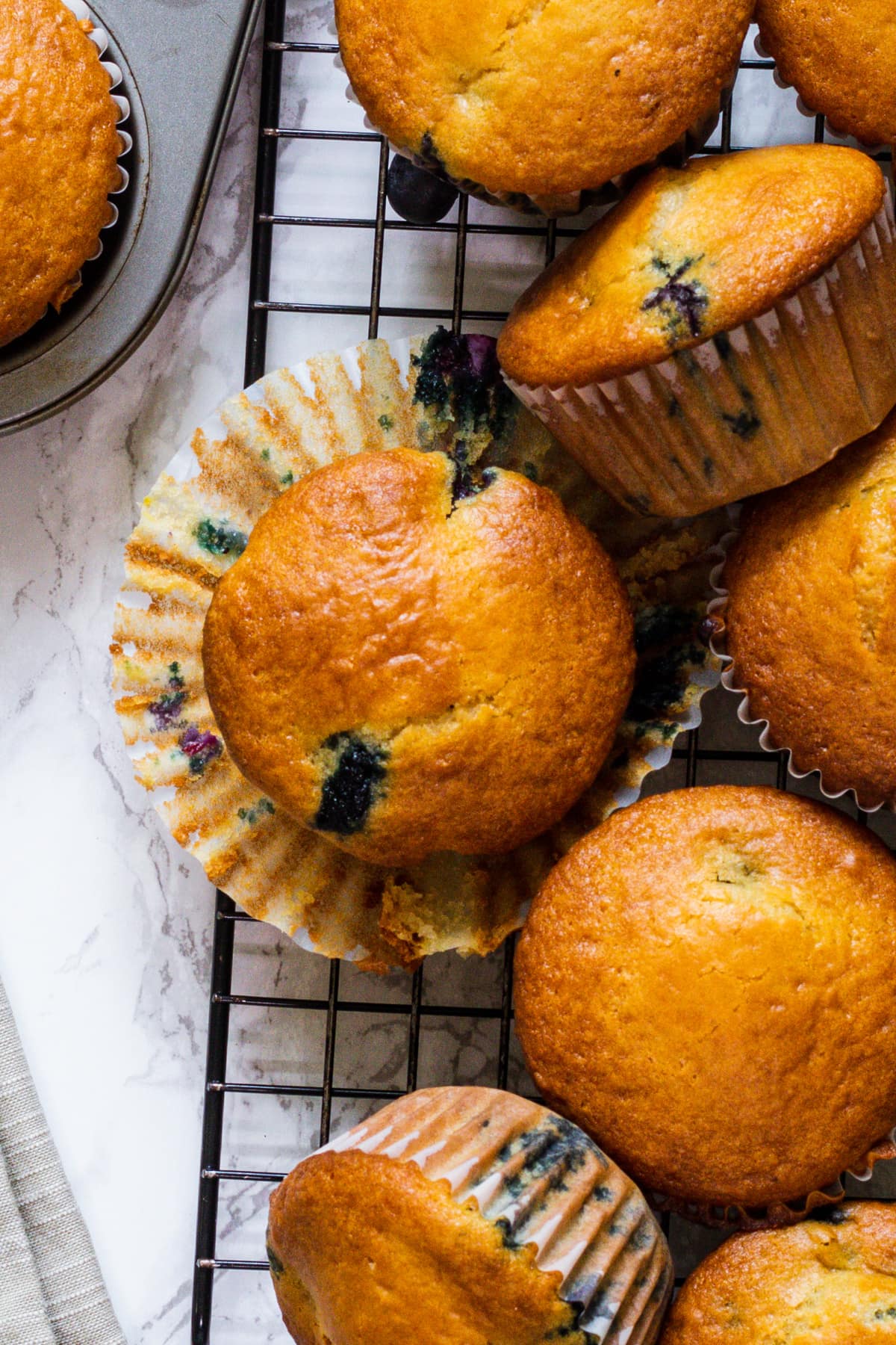 Close up of eggless blueberry muffin with muffin liner removed.