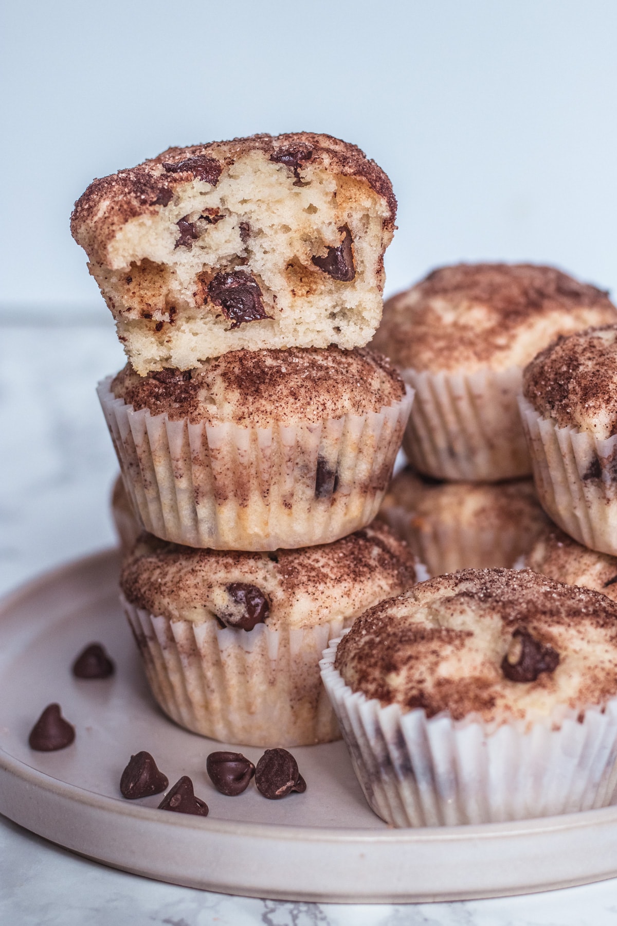 Close up image of eggless chocolate chip muffin with one bite taken