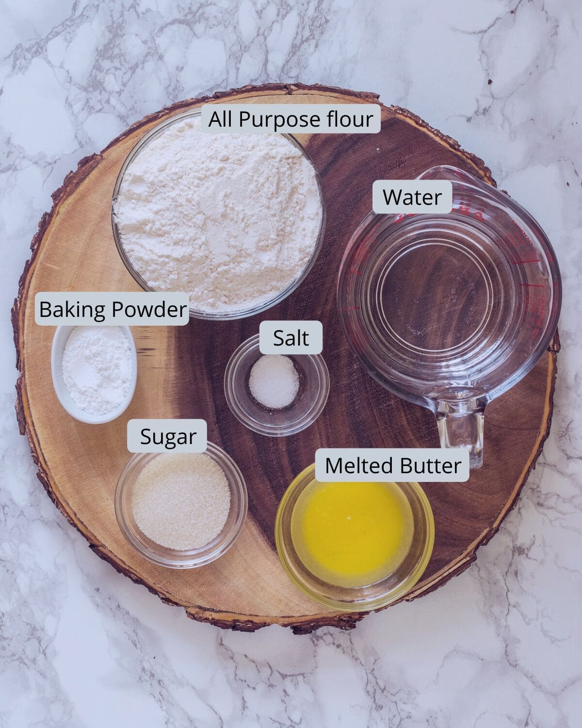 eggless pancake ingredients in individual bowls on a wooden board