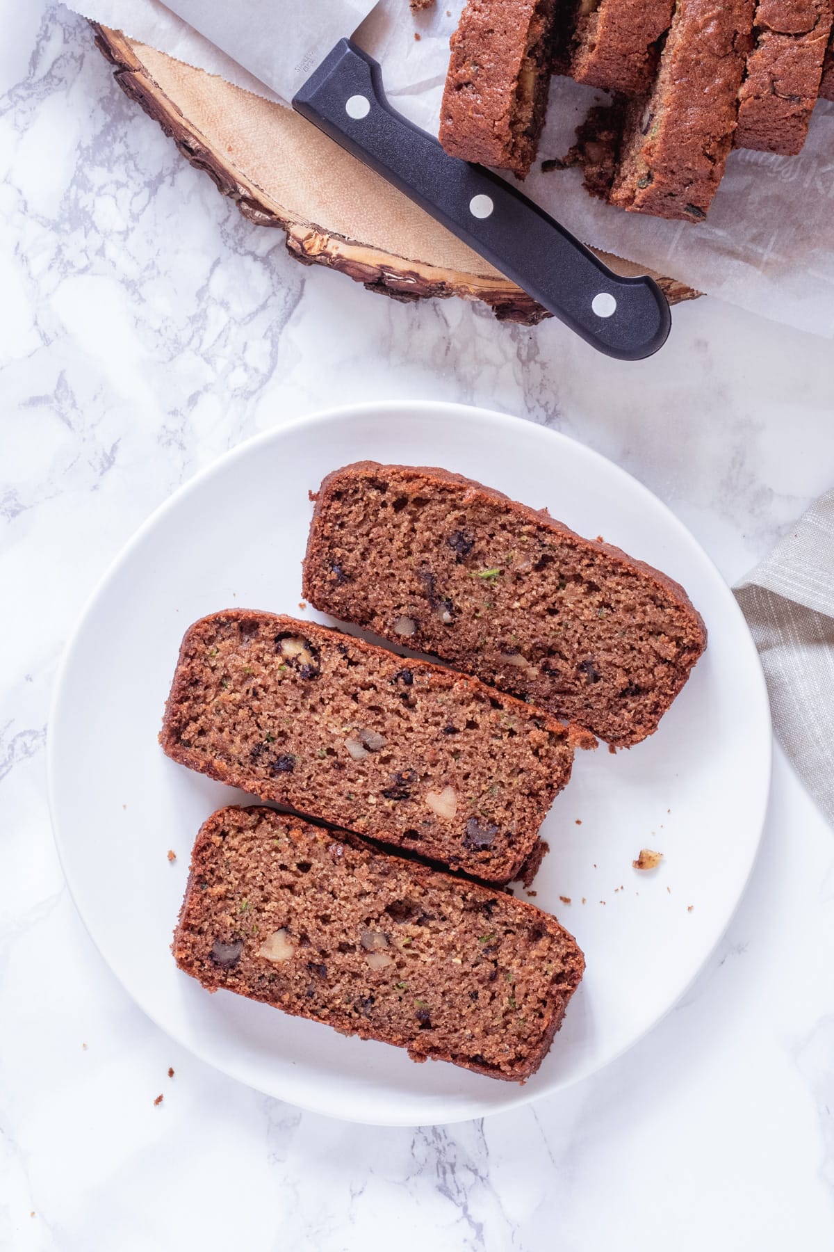 3 slices of eggless zucchini bread on a plate