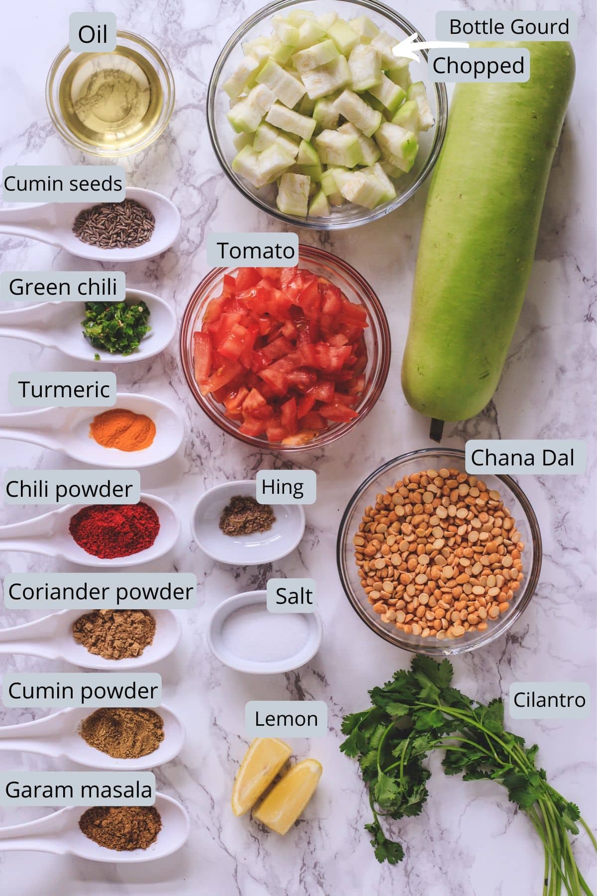 lauki chana dal ingredients in bowls and spoons on a marble surface