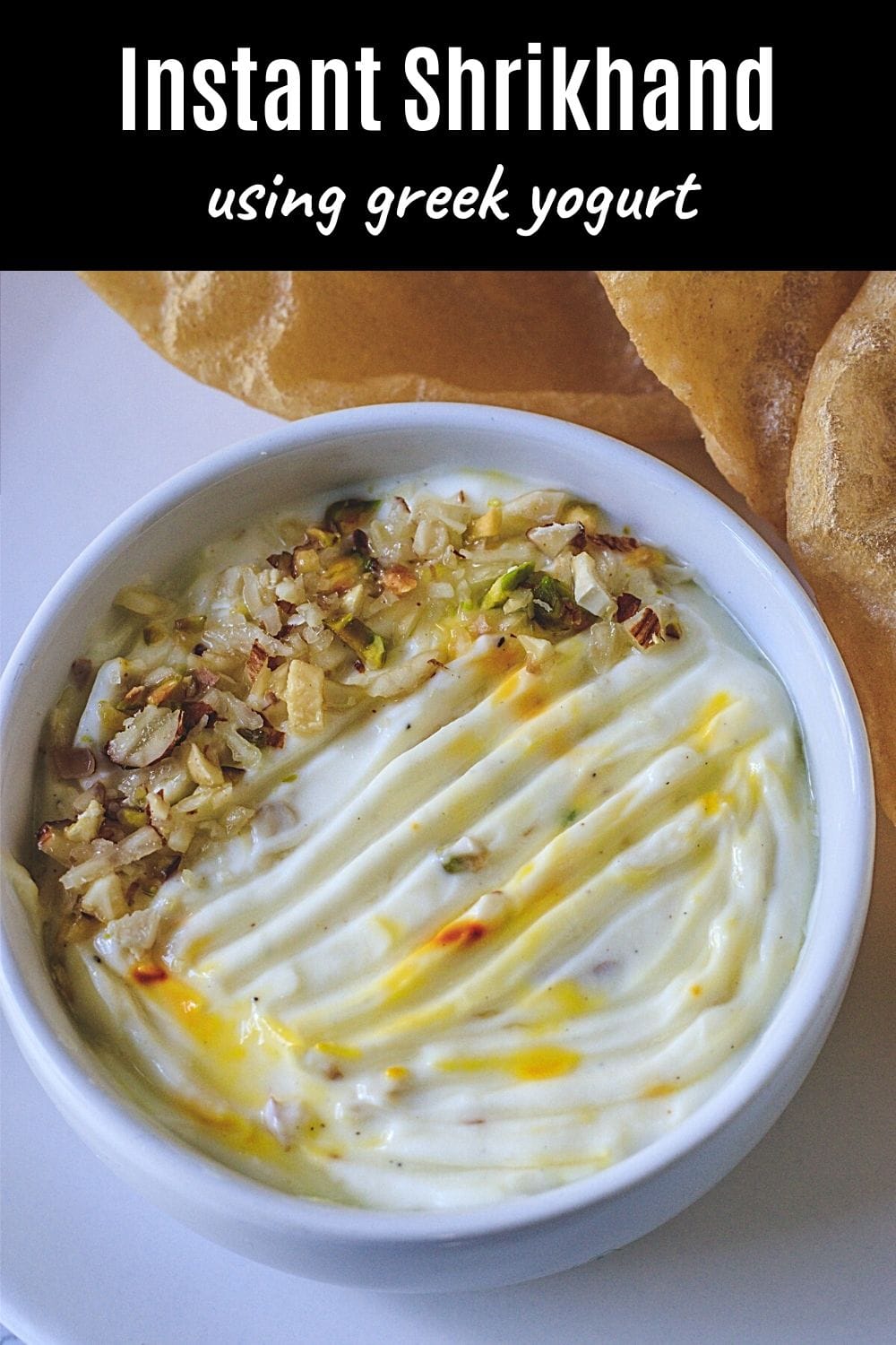 Shrikhand in a bowl with garnish of nuts with text on top for pinterest