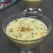 Basundi in a serving bowl with garnish of chopped nuts