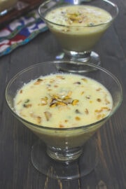 Basundi in a serving bowl with garnish of chopped nuts