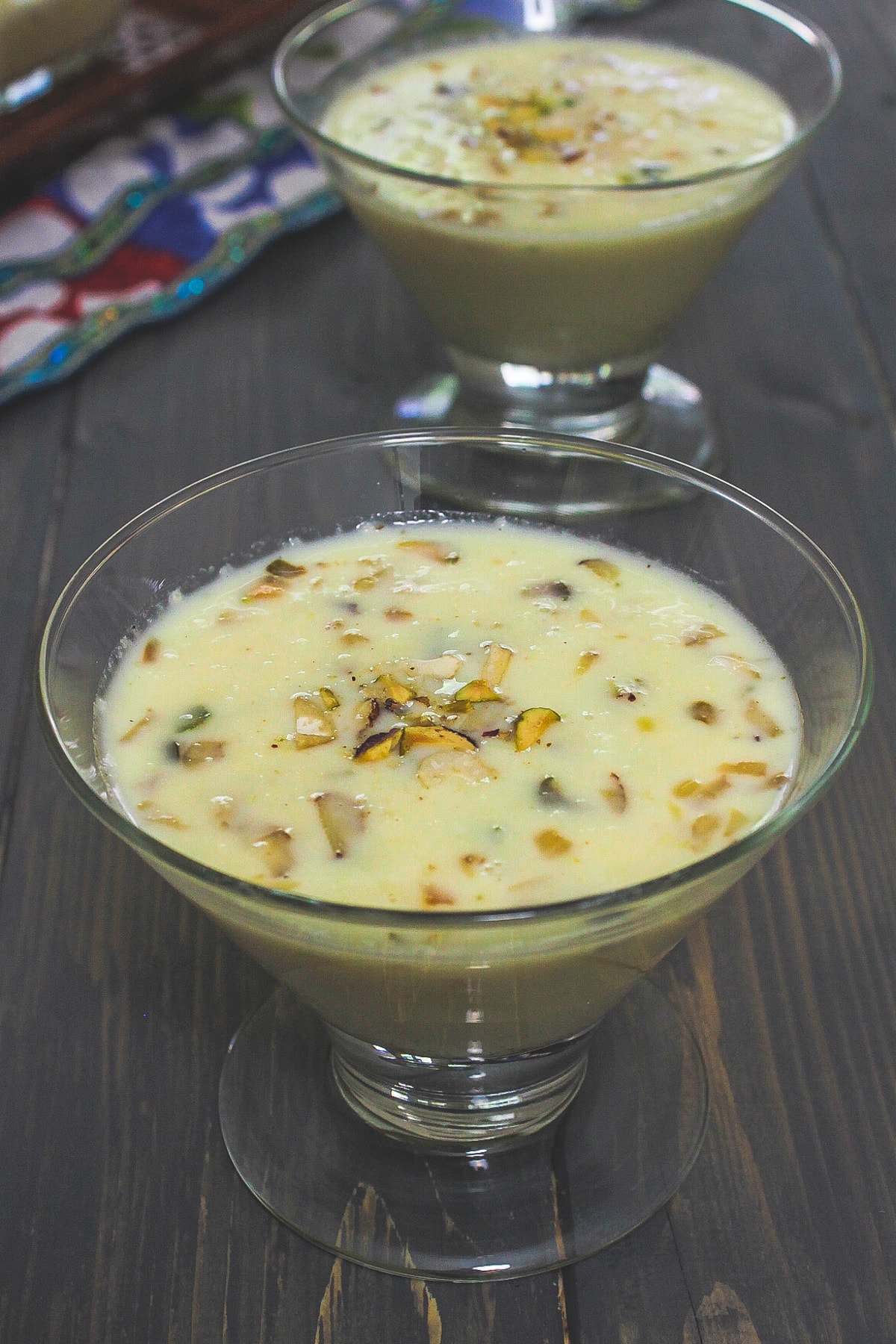 Basundi in a serving bowl with garnish of chopped nuts