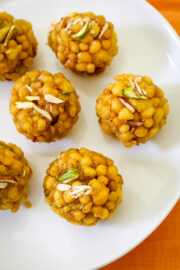 Close up shot of boondi ladoo garnished with chopped nuts